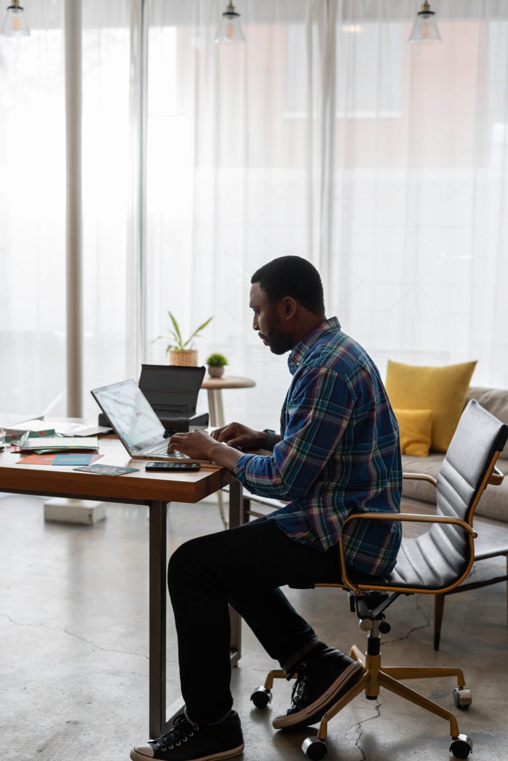 Person working on laptop at home desk